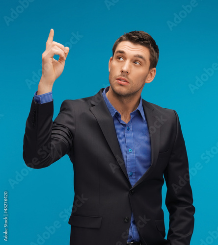 Photo: man in suit with his finger up man in suit with his finger up