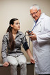 Doctor Checking Blood Pressure Of Woman