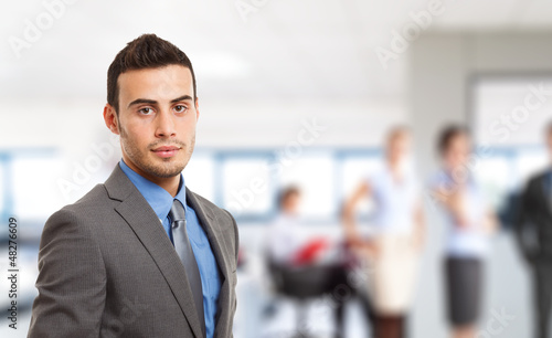Photo: Businessman in front of his team Businessman in front of his team