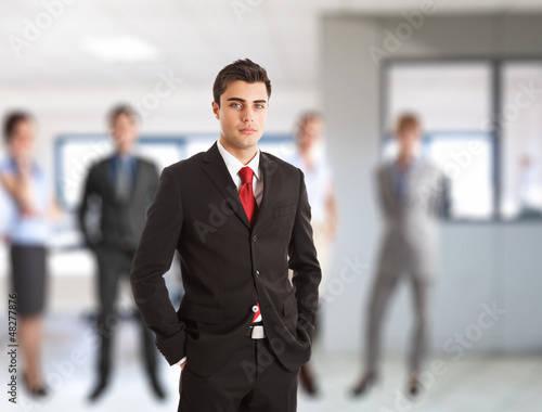 Photo: Businessman in front of his team Businessman in front of his team