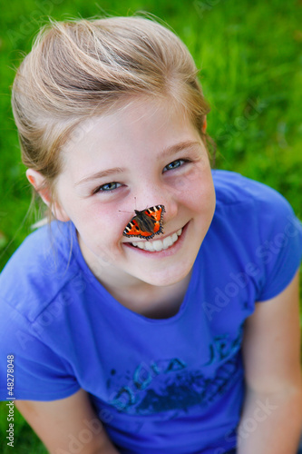 Photo: beautiful girl with a butterfly on her nose beautiful girl with a butterfly on her nose