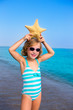child kid girl in summer beach vacations with starfish