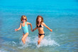 children girls friends running together in the beach shore