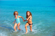 children girls friends running together in the beach shore