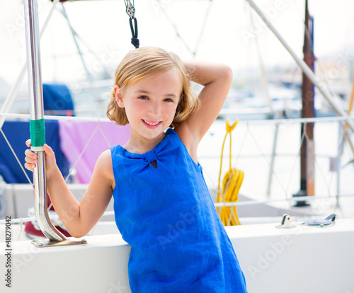 Photo: child kid girl in marina boat on summer vacations child kid girl in marina boat on summer vacations