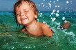Photo: Happy kid splashing in the sea Happy kid splashing in the sea