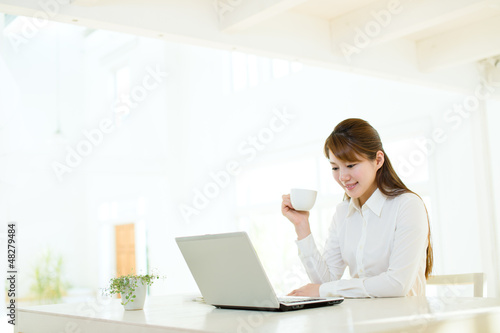 Photo: Beautiful asian businesswoman using a laptop computer Beautiful asian businesswoman using a laptop computer