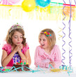 children happy girls blowing birthday party cake