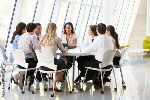 Photo: Business People Having Board Meeting In Modern Office Business People Having Board Meeting In Modern Office
