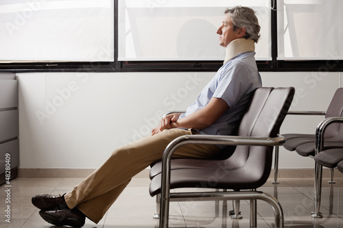 Photo: Man With Neck Injury Waiting In Lobby Man With Neck Injury Waiting In Lobby