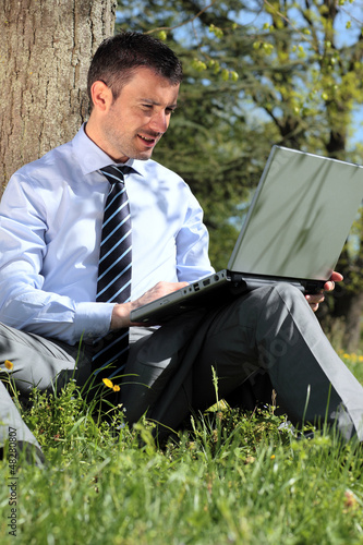 Photo: working with laptop in a park working with laptop in a park