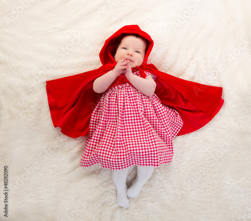 Photo: Baby Little Red Riding Hood on white fur Baby Little Red Riding Hood on white fur