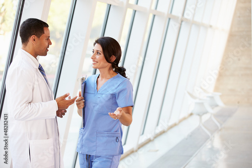 Photo: Medical Staff Having Discussion In Modern Hospital Corridor Medical Staff Having Discussion In Modern Hospital Corridor
