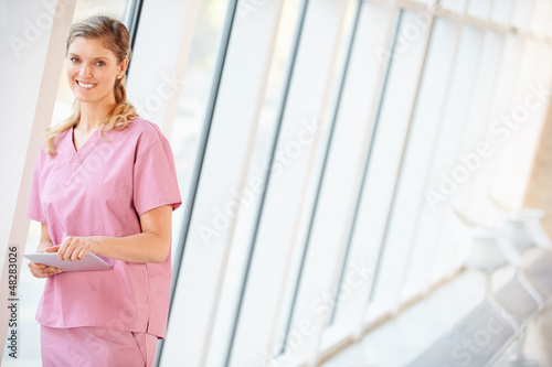 Photo: Nurse Using Digital Tablet In Corridor Of Modern Hospital Nurse Using Digital Tablet In Corridor Of Modern Hospital
