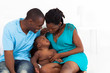 happy african american parents playing with baby boy in bedroom