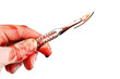 Bloody surgeon scalpel and hand , isolated