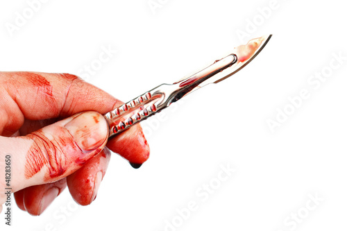 Photo: Bloody surgeon scalpel and hand , isolated Bloody surgeon scalpel and hand , isolated