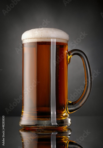 Photo: Mug of beer over black background Mug of beer over black background