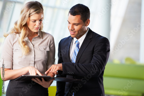Photo: Businessman And Businesswomen Having Informal Meeting In Office Businessman And Businesswomen Having Informal Meeting In Office