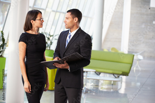 Photo: Businessman And Businesswomen Having Informal Meeting In Office Businessman And Businesswomen Having Informal Meeting In Office