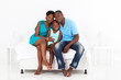 happy african family sitting on bed