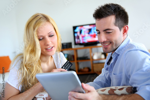 Photo: Young couple choosing tv program on internet Young couple choosing tv program on internet