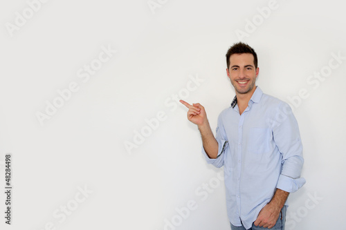 Photo: Cheerful young man showing message on whiteboard Cheerful young man showing message on whiteboard