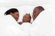 happy african american couple and baby boy sleeping