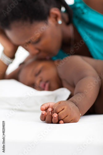 Photo: african american mother kissing sleeping baby african american mother kissing sleeping baby