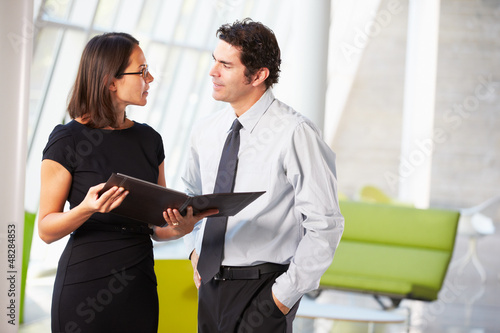 Photo: Businessman And Businesswomen Having Meeting In Office Businessman And Businesswomen Having Meeting In Office