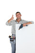 Photo: Thumbs up from a builder with a blank board Thumbs up from a builder with a blank board