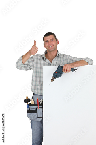 Photo: Thumbs up from a builder with a blank board Thumbs up from a builder with a blank board