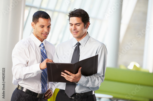 Photo: Two Businessmen Having Informal Meeting In Modern Office Two Businessmen Having Informal Meeting In Modern Office