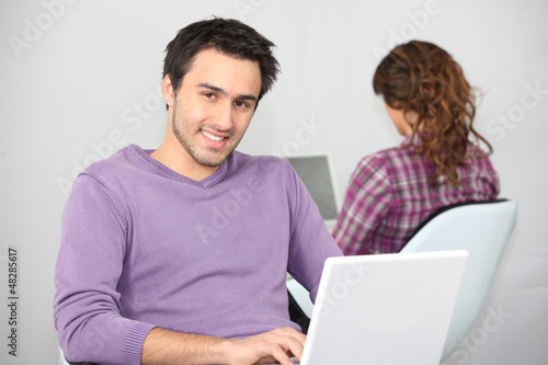 Photo: Twentysomethings using laptop computers Twentysomethings using laptop computers