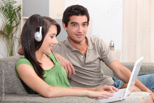 Photo: Teens sitting on couch Teens sitting on couch