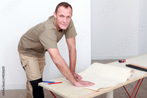 Photo: Manual worker wallpapering Manual worker wallpapering