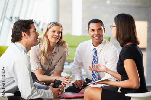 Photo: Businesspeople With Digital Tablet Having Meeting In Office Businesspeople With Digital Tablet Having Meeting In Office
