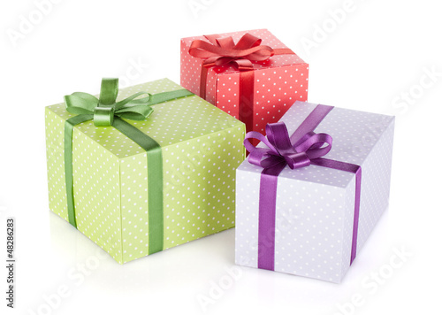 Photo: Three colorful gift boxes with ribbon and bow Three colorful gift boxes with ribbon and bow