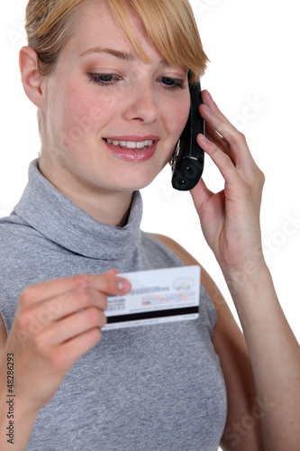 Photo: Woman on the phone with her credit card company Woman on the phone with her credit card company