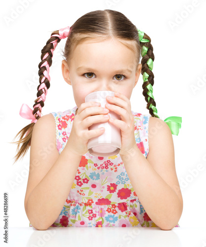 Photo: Cute little girl with a glass of milk Cute little girl with a glass of milk