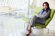 Portrait Of Businesswoman Sitting On Sofa In Modern Office