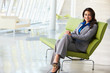 Portrait Of Businesswoman Sitting On Sofa In Modern Office
