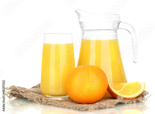 Photo: Full glass and jug of orange juice and oranges isolated on Full glass and jug of orange juice and oranges isolated on