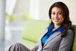 Photo: Portrait Of Businesswoman Sitting On Sofa In Modern Office Portrait Of Businesswoman Sitting On Sofa In Modern Office