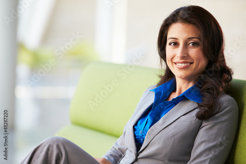 Photo: Portrait Of Businesswoman Sitting On Sofa In Modern Office Portrait Of Businesswoman Sitting On Sofa In Modern Office