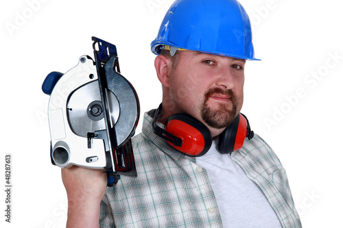 Photo: Bearded man holding circular-saw Bearded man holding circular-saw