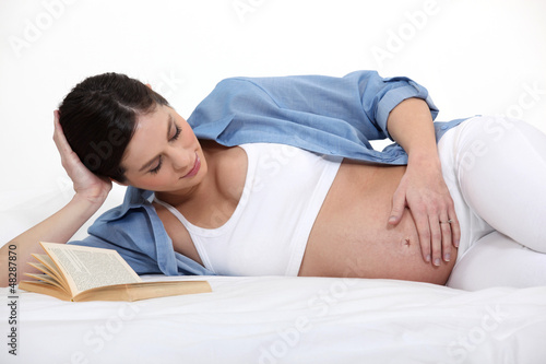Photo: pregnant woman lying in her bed pregnant woman lying in her bed