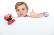 Little girl with binoculars and blank poster