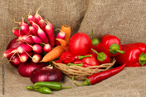 Photo: fresh red vegetables on sackcloth background fresh red vegetables on sackcloth background