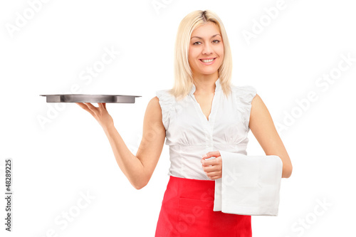 Photo: A smiling female waitress holding a tray A smiling female waitress holding a tray